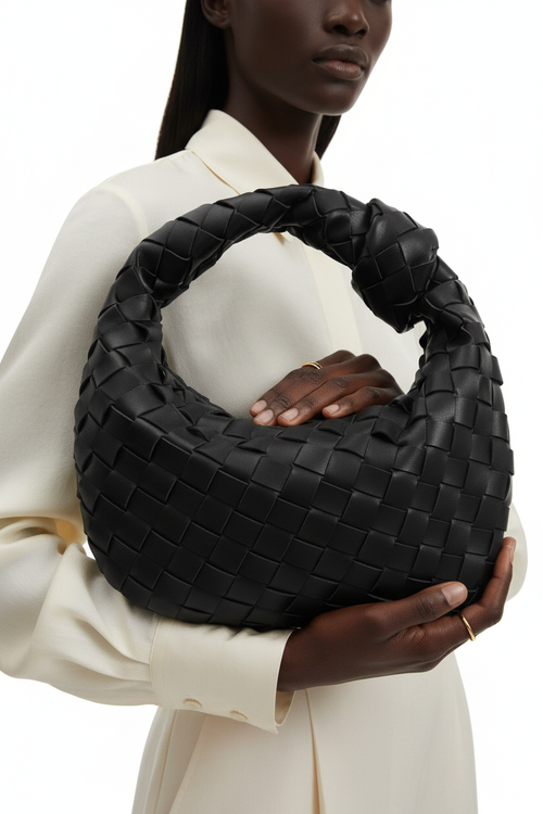 Dark model with black woven knot bag