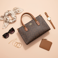 Coach signature handbag flat lay with fashion accessories