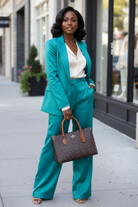 Black woman carrying luxury Coach handbag - fashion styling