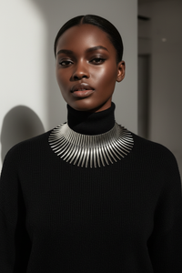Model in black turtleneck with statement silver necklace